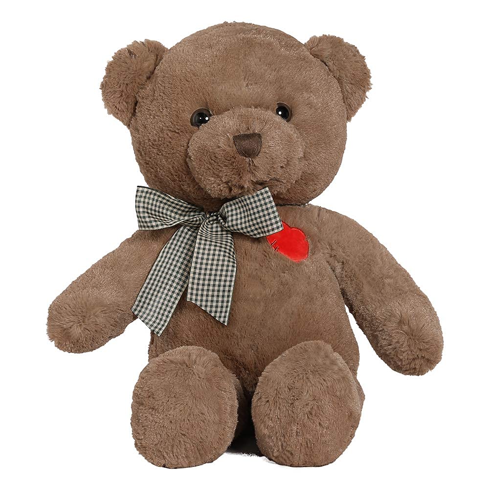 A brown plush teddy bear sitting upright on a white background, wearing a black-and-white gingham bow around its neck and a small red heart patch on the chest.