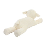 A cream-colored sheep plush toy lying down, photographed on a seamless white studio background.