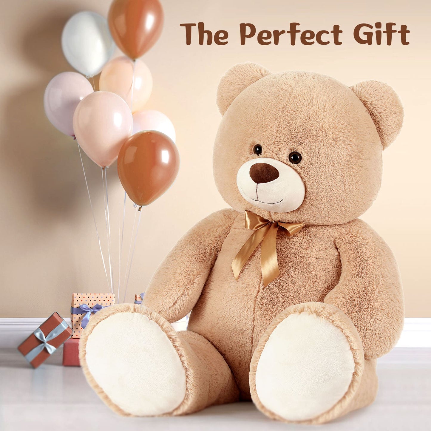Teddy bear with a gold bow, balloons, and small gifts on a light background with 'The Perfect Gift' text.