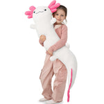 Child holding a large axolotl plush toy on a white background
