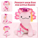 Cute pink axolotl graduation plush wearing a black mortarboard and bright graduation sash, holding a certificate, ideal for celebrating high school or college graduation achievements.