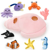 A pink plush Conch with seven ocean-themed stuffed animals: Jellyfish, Whale, Hermit Crab, Starfish, Seahorse, Coral, Glow Fish, and Clownfish.