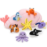 A pink plush Conch with seven ocean-themed stuffed animals: Jellyfish, Whale, Hermit Crab, Starfish, Seahorse, Coral, Glow Fish, and Clownfish.