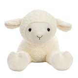 A fluffy cream-colored plush lamb toy with a soft textured fleece body, small black eyes, and a simple embroidered smile, sitting against a clean white background.