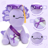 Cute kawaii axolotl plush toy in graduation theme, featuring mortarboard hat, congratulatory sash, and certificate scroll, perfect for graduation party decoration or gift.